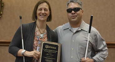 Alison Steven of Idaho winner of the Blind Educator of the Year award holding her plaque with Dr Edward Bell.