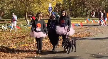 On a lovely fall day, three NFB of Idaho members participate in a Halloween 5K walk.